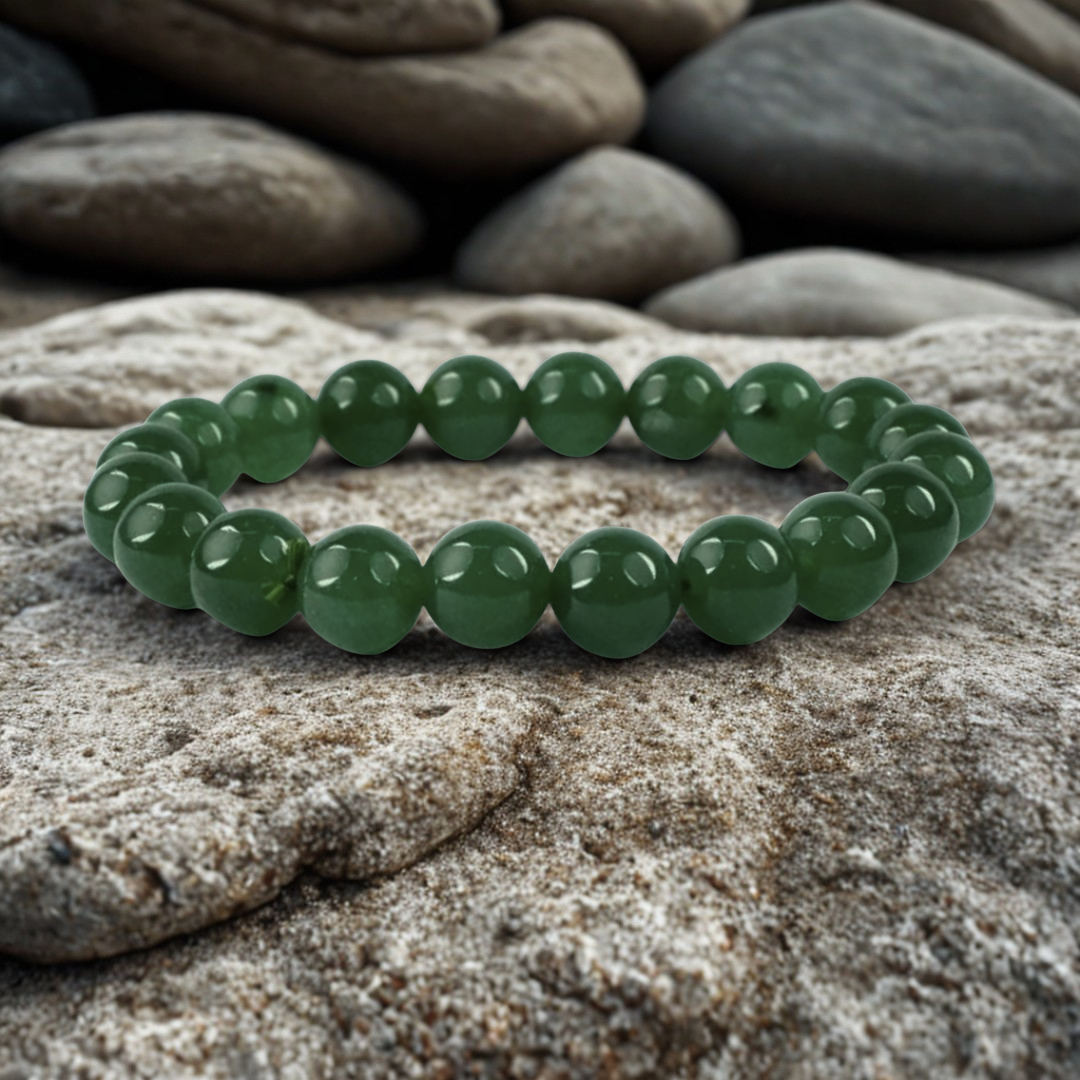 Green beaded Jade bracelet on a stone surface
