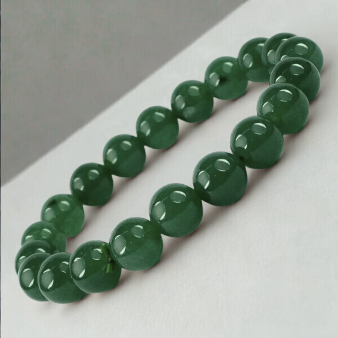 Green beaded Jade bracelet on a white surface with a gray background