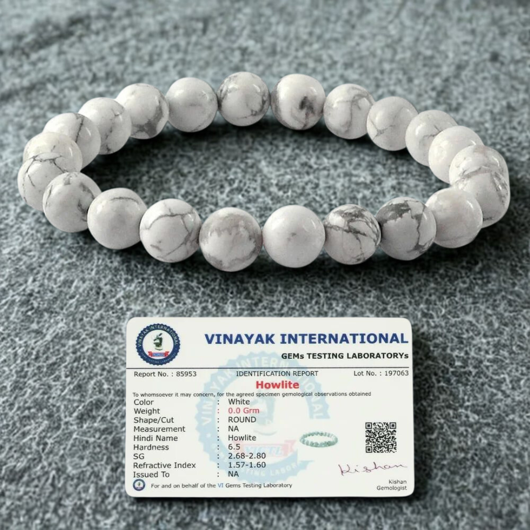White howlite beaded bracelet with a Vinayak International gemstone certification card on a gray background