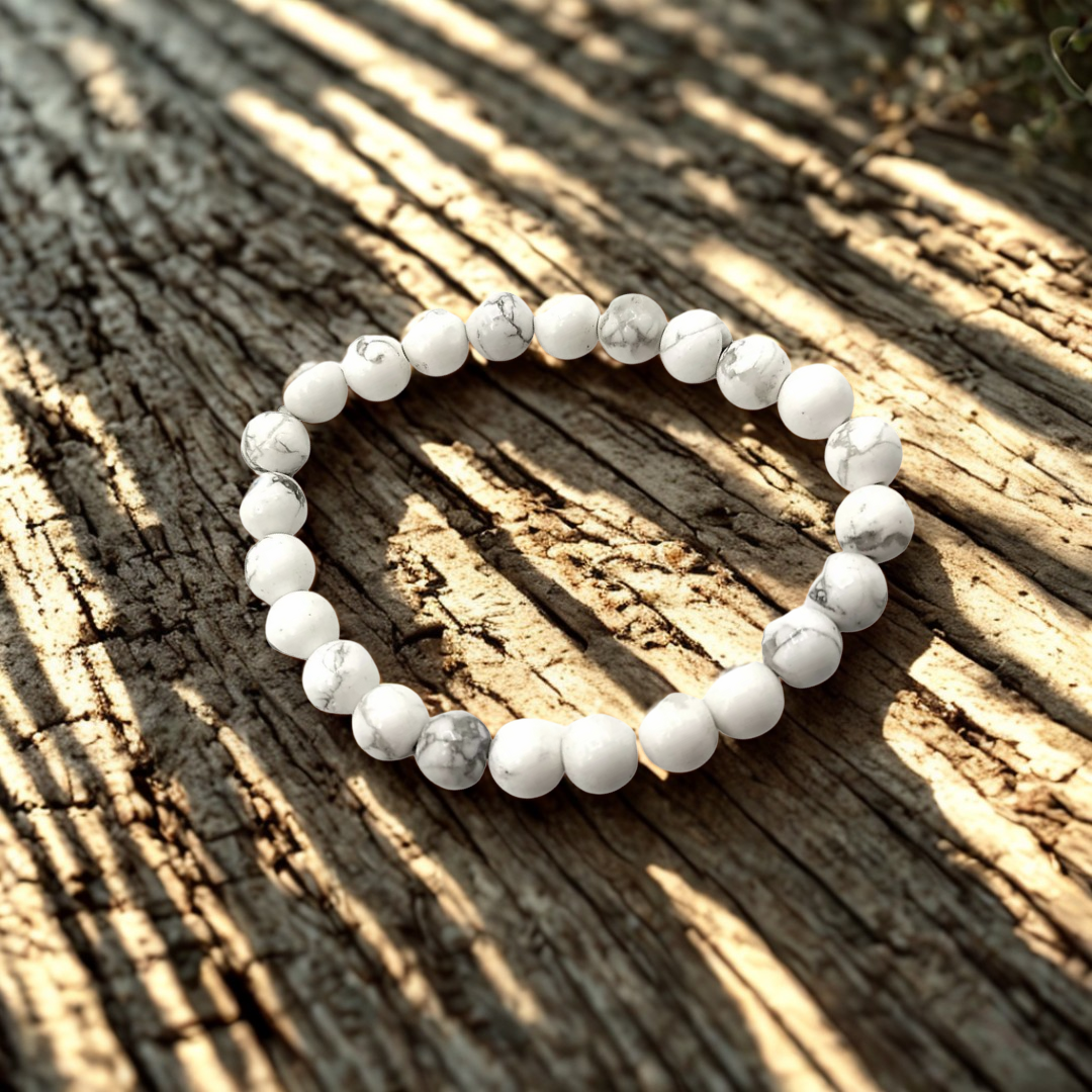White beaded bracelet on a textured wooden surface