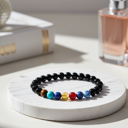 7 Chakra Gemstone Bracelet with colored beads on a marble surface