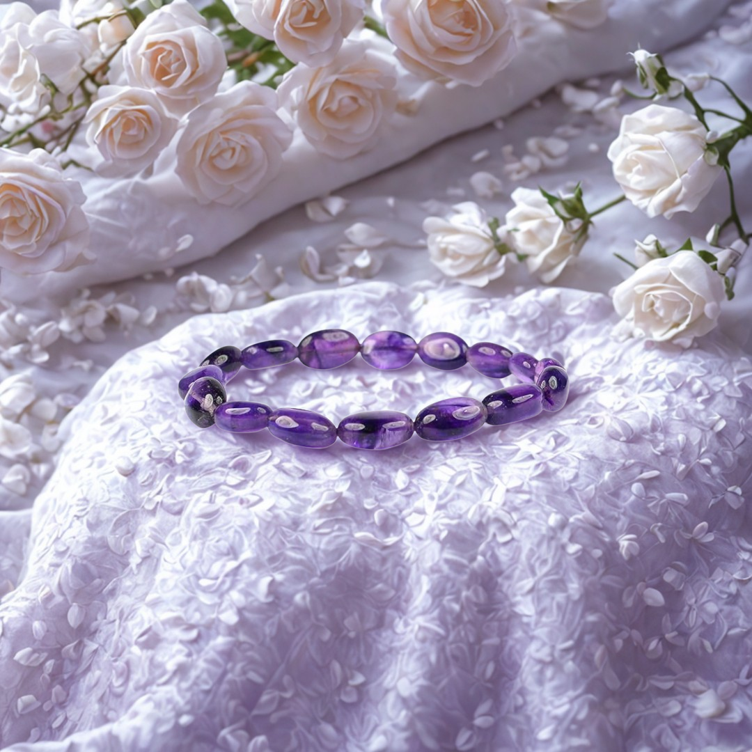 Purple beaded bracelet on a textured white surface with white flowers