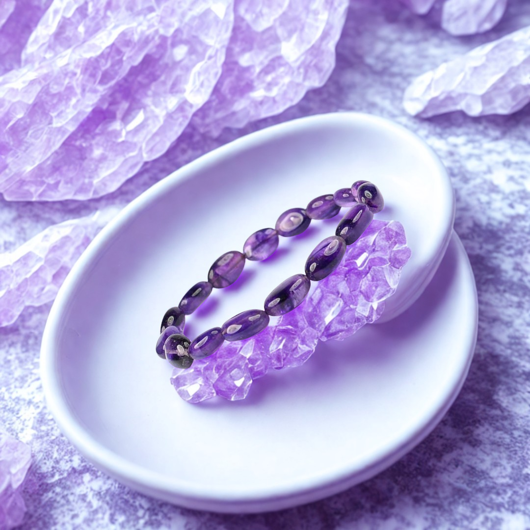 Purple beaded bracelet on a white dish with purple crystals in the background