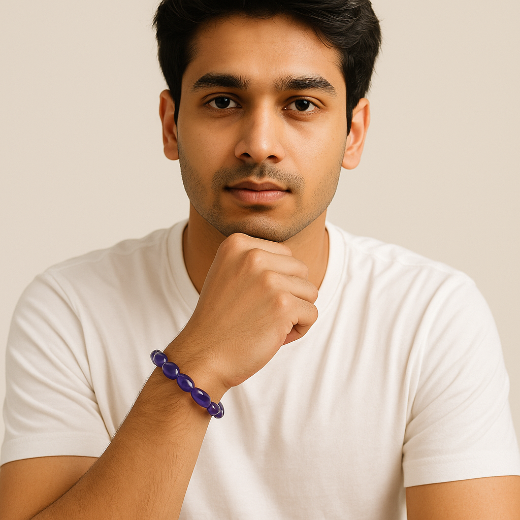 Man wearing a white t-shirt and purple bracelet against a beige background