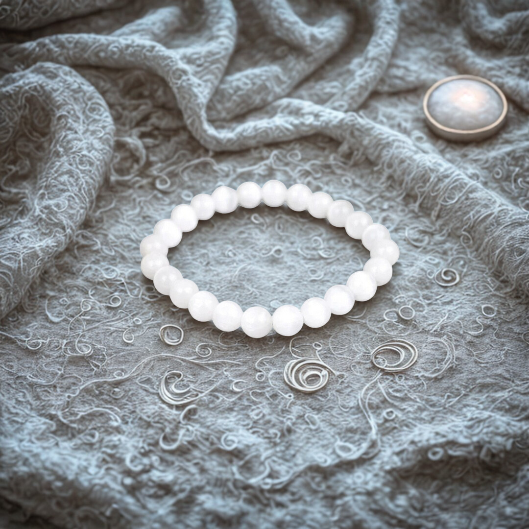 White beaded bracelet on a textured gray fabric background