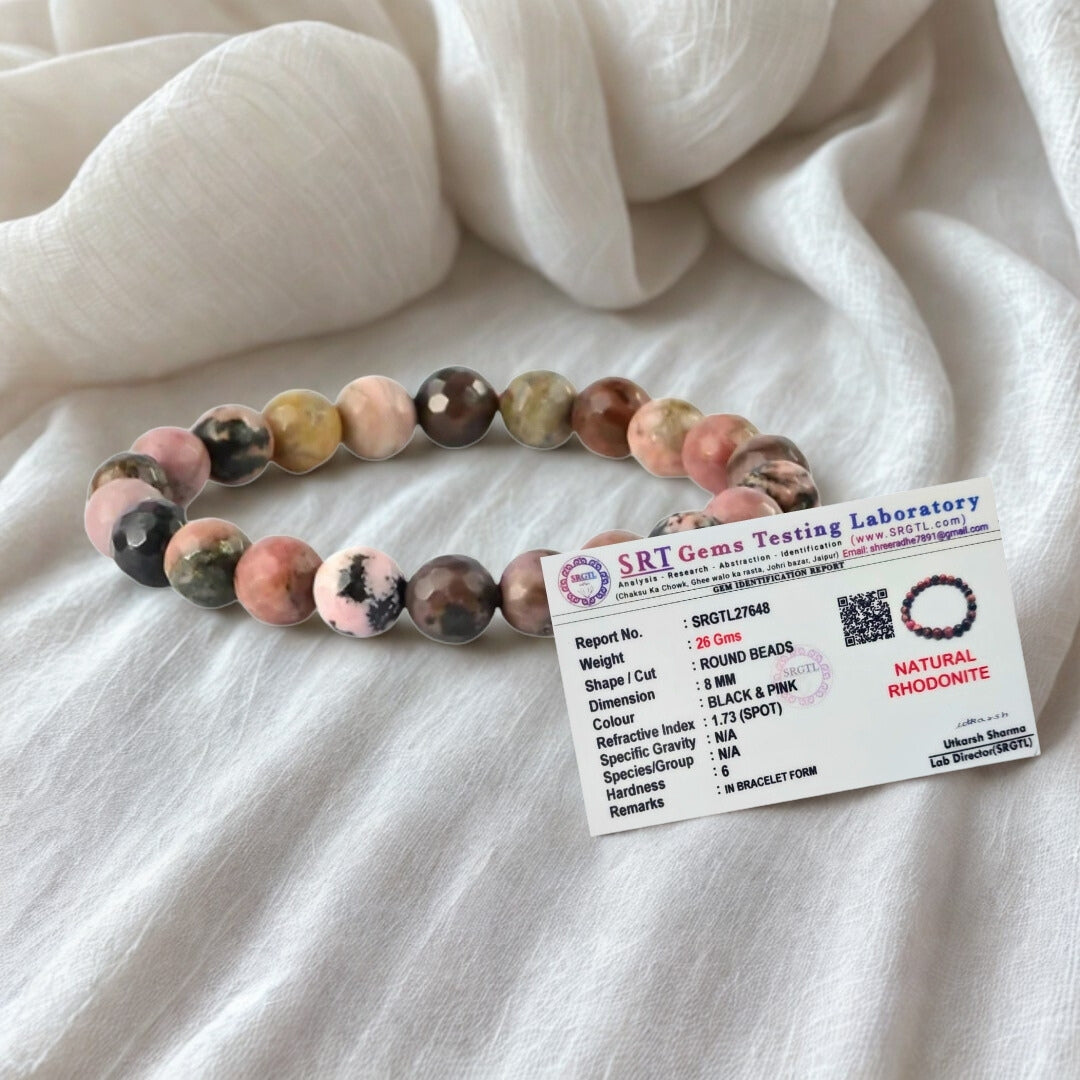 Multicolored beaded bracelet with a label on a white fabric background