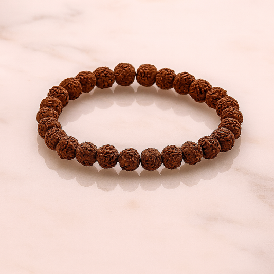 5 Mukhi Rudraksha Bracelet on a light pink background