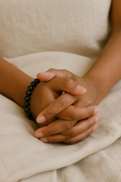 Close-up of hands clasped together with a focus on texture and skin tones.