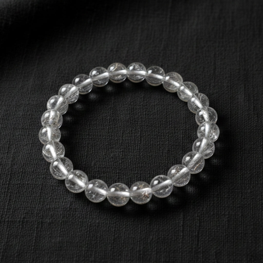 Silver beaded bracelet on a black background