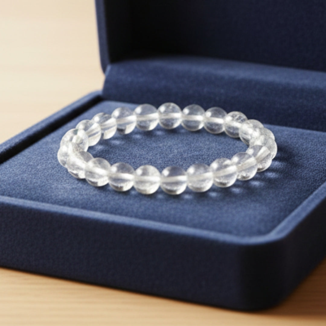 Clear beaded bracelet on a blue jewelry box