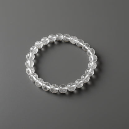 Clear beaded bracelet on a dark gray background