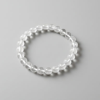 Clear beaded bracelet on a gray background