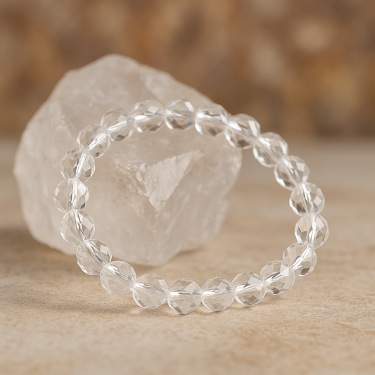 Clear Quartz Sphatik Gemstone Bracelet on a stone surface with a blurred natural background