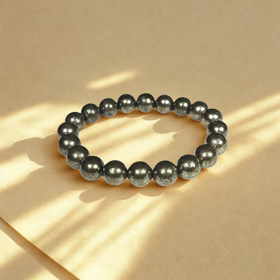 Black beaded bracelet on a beige background