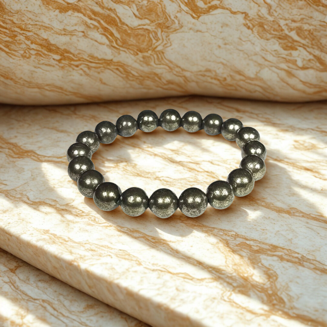 Black beaded bracelet on a marble surface