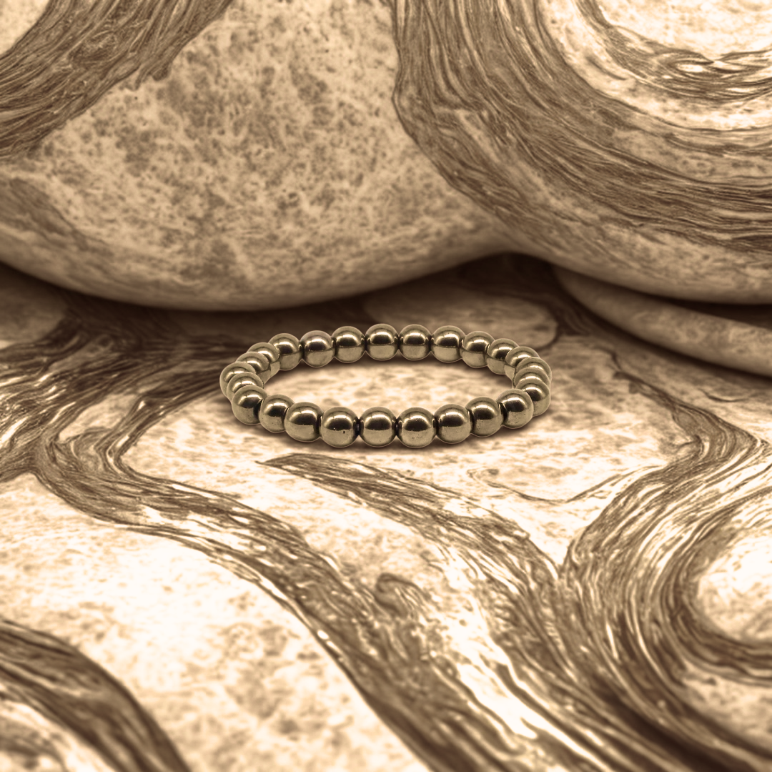 Silver beaded bracelet on textured stone surface