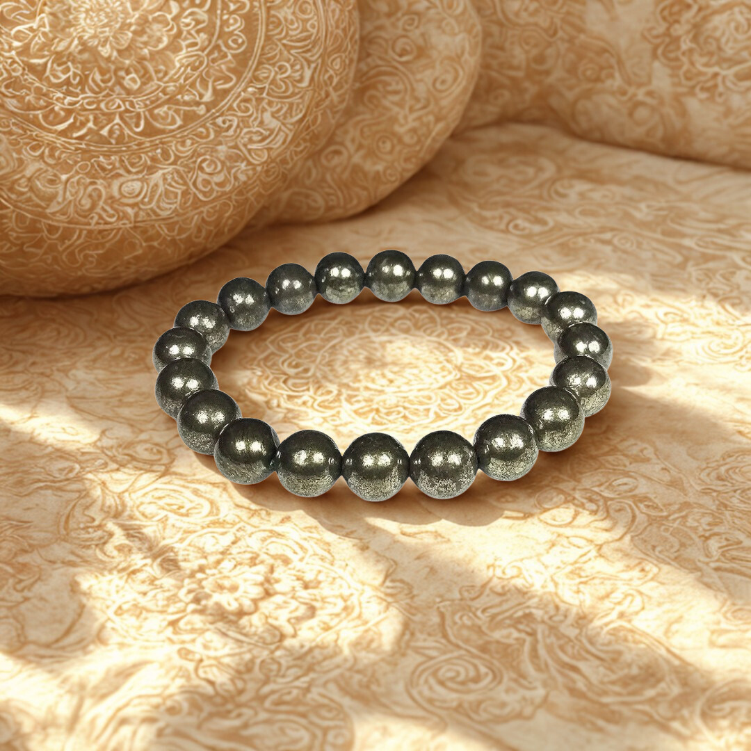 Black beaded bracelet on a textured beige surface