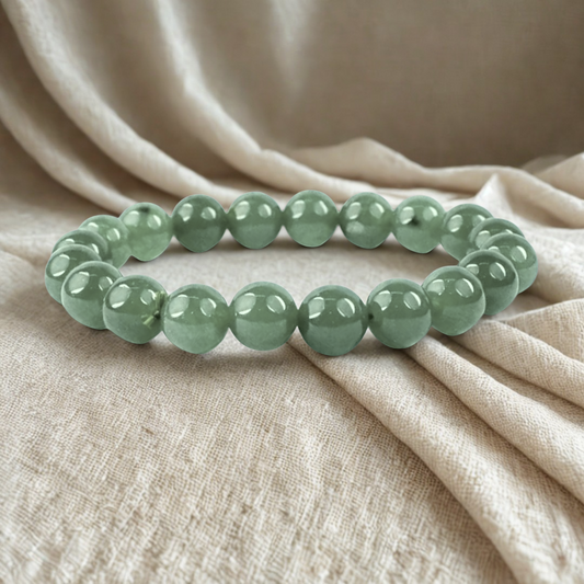 Green aventurine bracelet on a silk cloth

