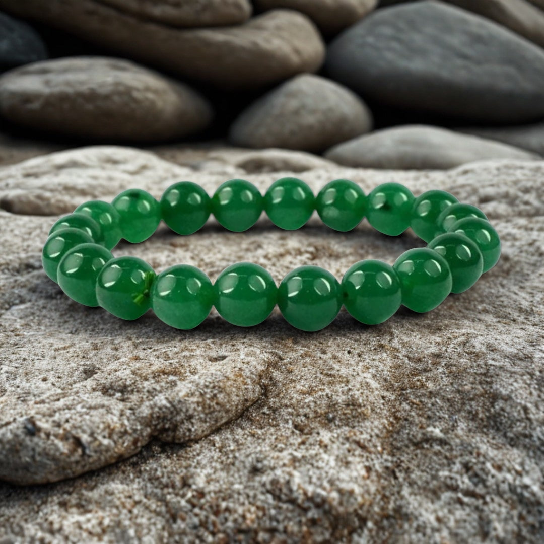 Green beaded bracelet on a stone surface