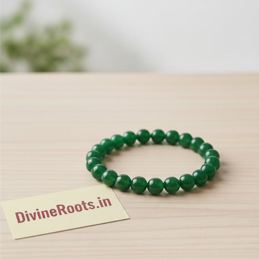 Green Jade Gemstone Bracelet on a wooden surface with a 'DivineRoots.in' card.