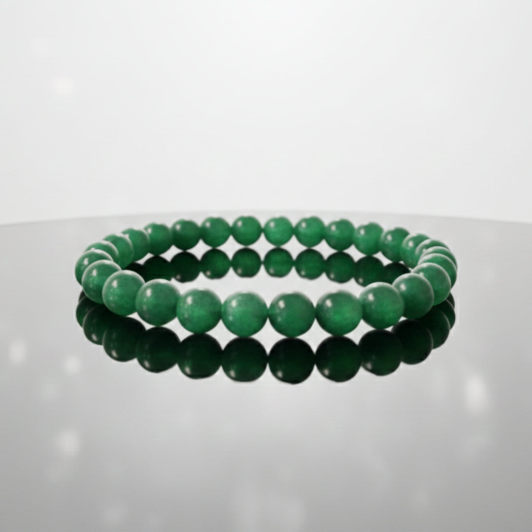 Two green beaded bracelets on a reflective surface with a white background