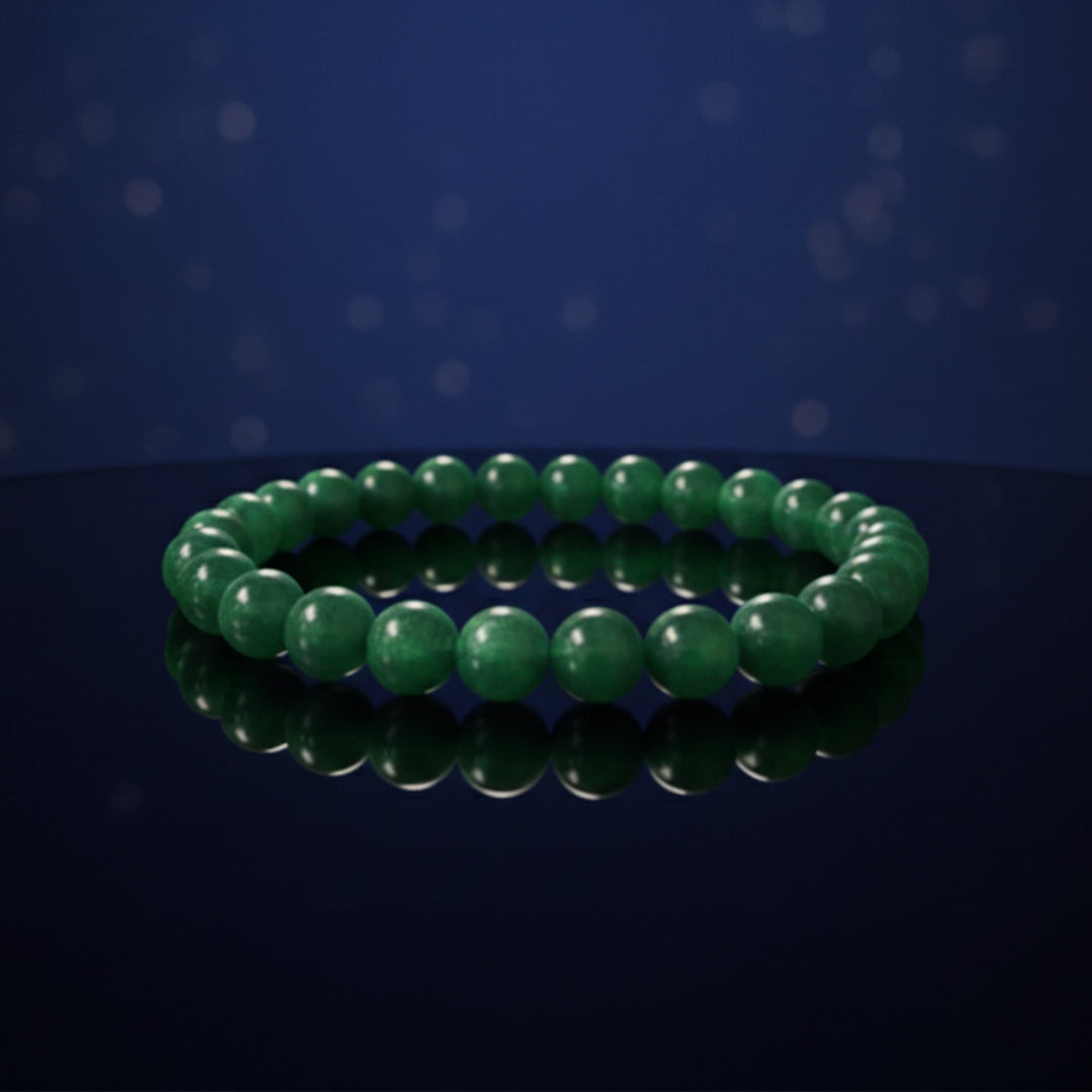 Green beaded bracelet on a reflective surface with a dark blue background