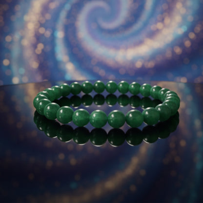 Green beaded bracelet on a reflective surface with a swirling, multicolored background