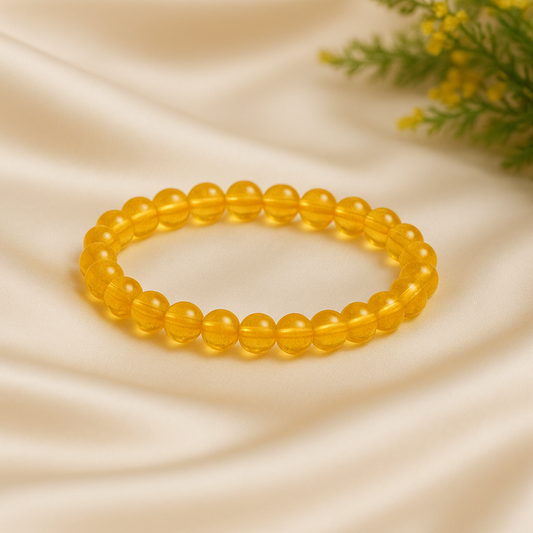 Heated Citrine Gemstone Bracelet on a beige fabric background with greenery