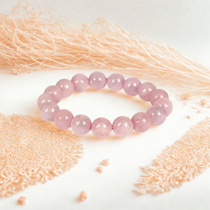Pink beaded bracelet on a textured white surface