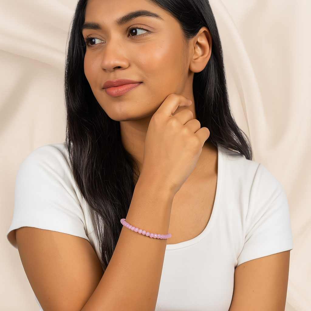 Woman wearing a pink bracelet on a beige background