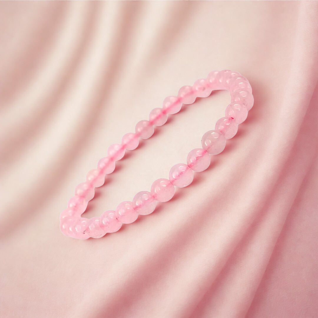 Pink beaded bracelet on a pink fabric background
