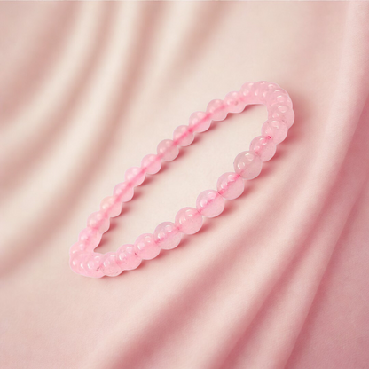 Pink beaded bracelet on a pink fabric background