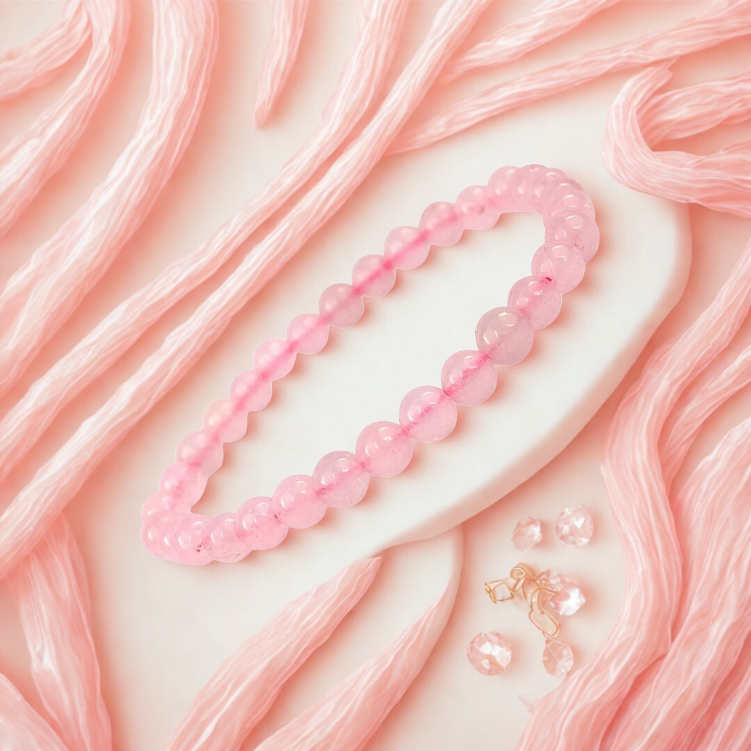 Pink beaded necklace on a pink textured background