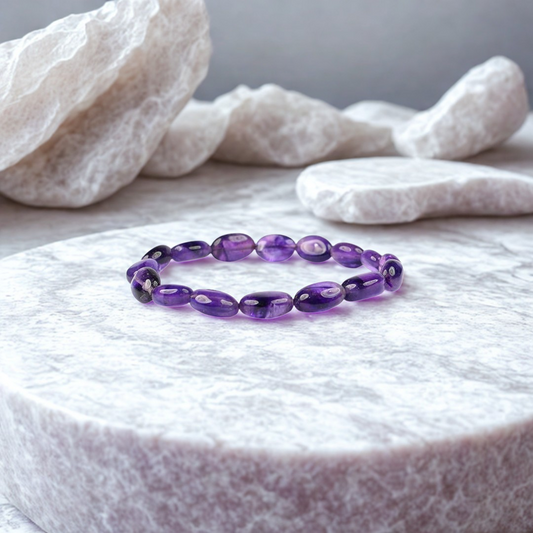 Purple beaded bracelet on a white stone surface