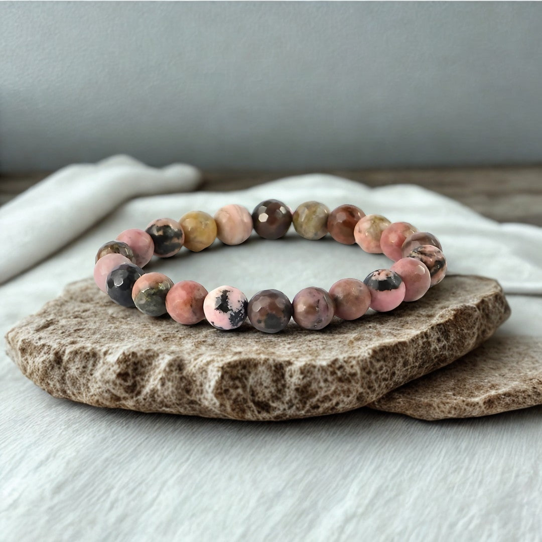 Multicolored beaded bracelet on a stone surface with a neutral background