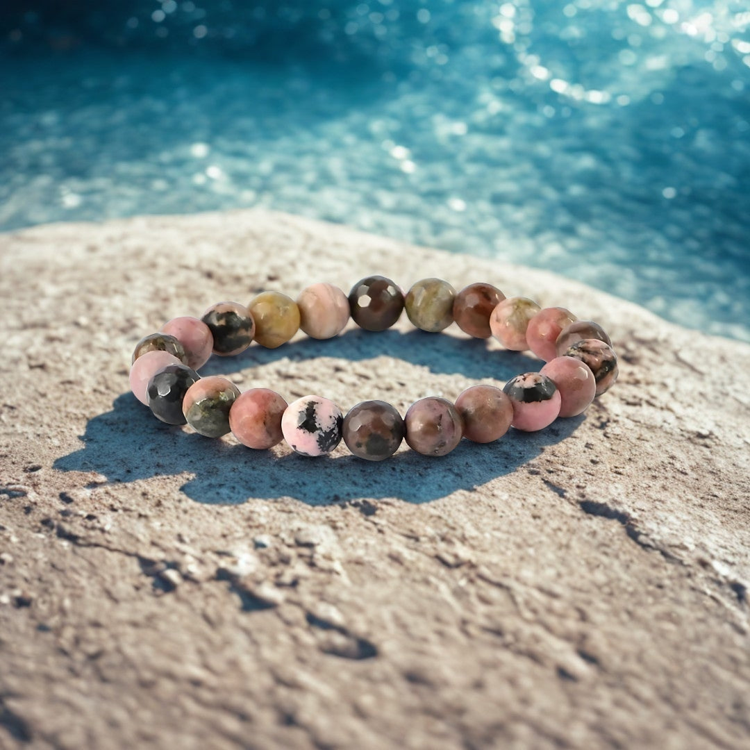Multicolored beaded bracelet on a rock with water in the background