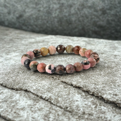 Multicolored beaded bracelet on a textured surface