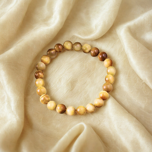 Yellow Cat Eye Gemstone Bracelet  on a beige fabric background
