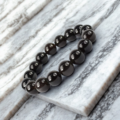 Black beaded bracelet on a marble surface