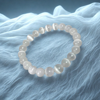 Pearl bracelet on a textured blue fabric background