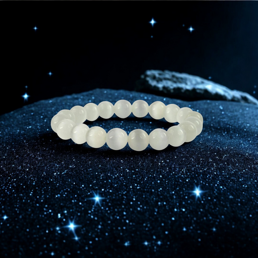 Selenite Gemstone Bracelet on a dark, starry background