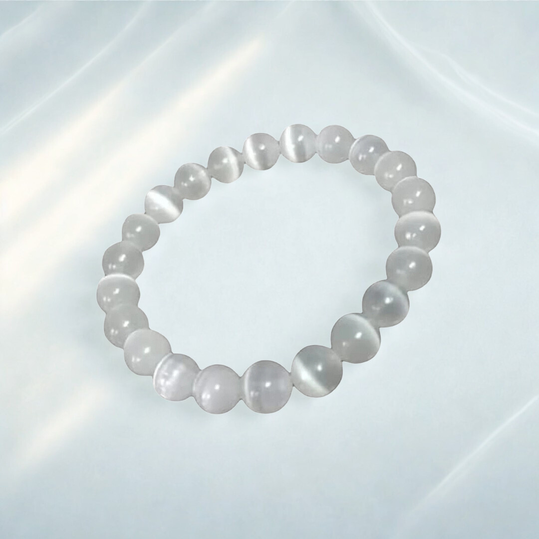 Pearl bracelet on a reflective white surface