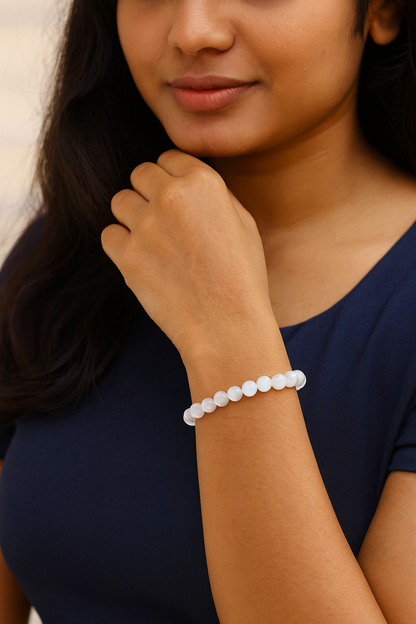 Woman wearing a white beaded bracelet on her wrist