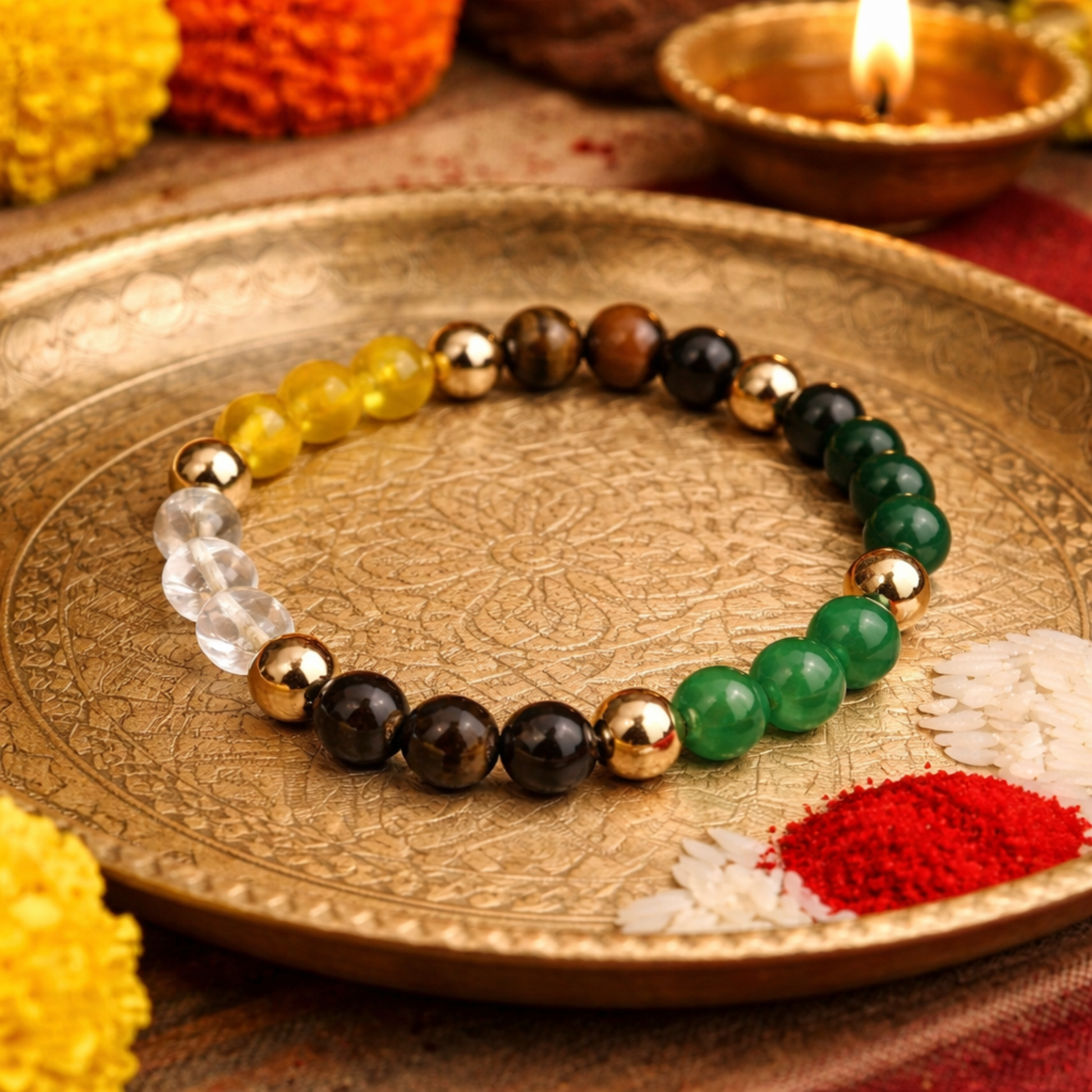 Citrine, Tiger Eye, Jade, Aventurine, Pyrite, Spahatik (Clear Quartz) and Hematite beaded Dhan Yog bracelet on a decorative plate with Diwali decorations.