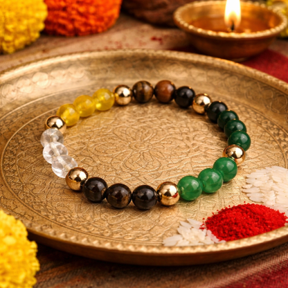 Citrine, Tiger Eye, Jade, Aventurine, Pyrite, Spahatik (Clear Quartz) and Hematite beaded Dhan Yog bracelet on a decorative plate with Diwali decorations.