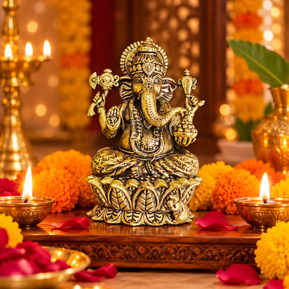Ganesha idol in traditional festive pooja setting with marigold flowers and glowing diya