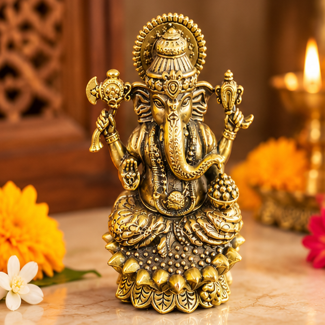 Brass Ganesha idol on decorative lotus pedestal, top front view showing ornate crown and four arms