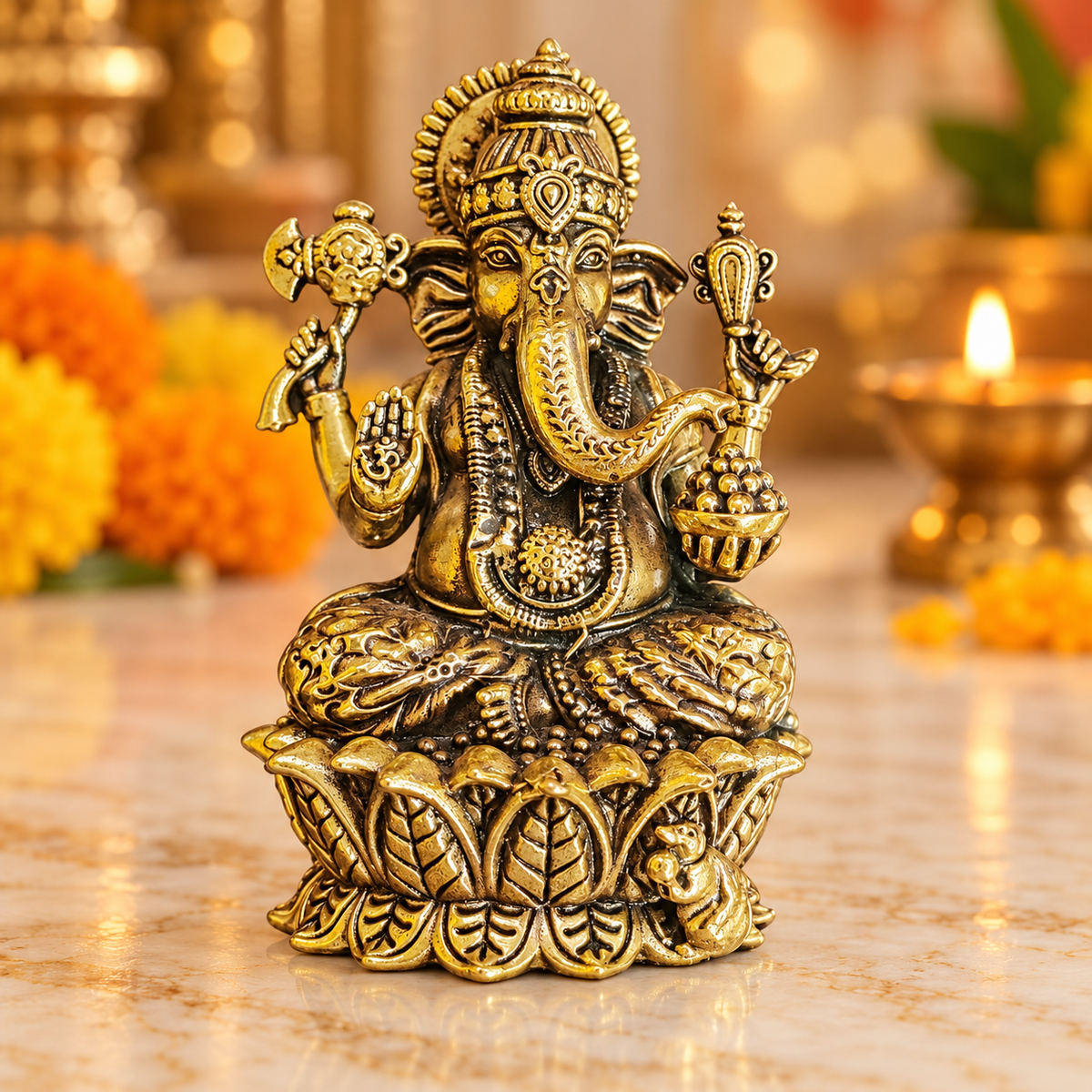 Brass Ganesha idol on decorative lotus pedestal, front view showing ornate crown and four arms