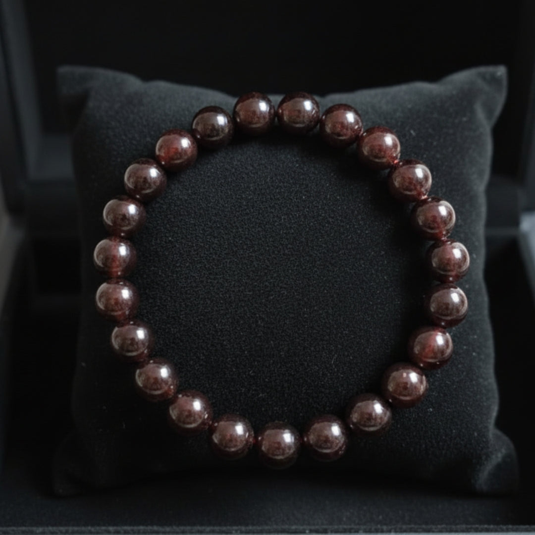 Natural reddish-brown Garnet bracelet on a black jewellery cushion