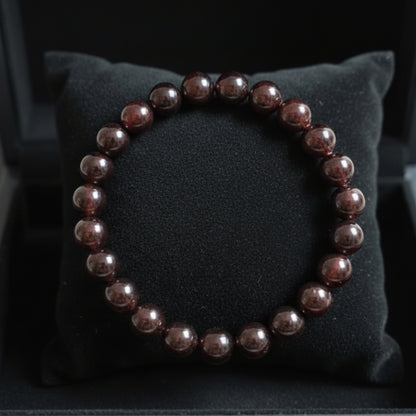 Natural reddish-brown Garnet bracelet on a black jewellery cushion